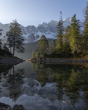 Eibsee lake with Zugspitze, water reflection, trees, Garmisch-Partenkirchen, Germany