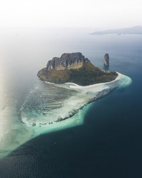 Aerial view, Chicken island at sunset with offshore reef, Koh Poda island, Krabi province, Thailand