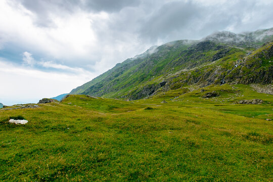 Romania mountain landscape in summer. scenic view of Fagaras ridge under overcast sky. rainy weather forecast background
