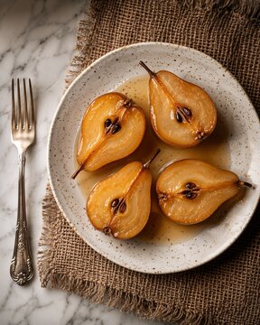 Sliced poached pears on a plate with spices and fork  