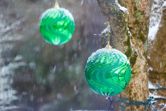 Large Christmas Ornament Outside During a Snowfall