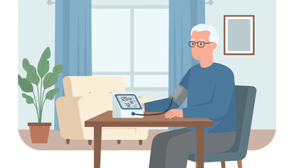 Fototapeta premium Elderly man with glasses sits at a table while measuring his blood pressure using an automated electronic monitor in his quiet living room.