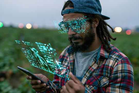 Farmer Using Smart Glasses and Holographic Data in Field