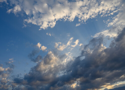 Beautiful evening sky showcasing dramatic clouds and soft light as the sun sets behind the horizon