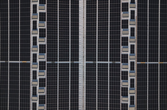 Portugal - 14 August 2026: Aerial view of solar panels installed on a large industrial factory rooftop, showcasing decentralized energy production in Portugal.