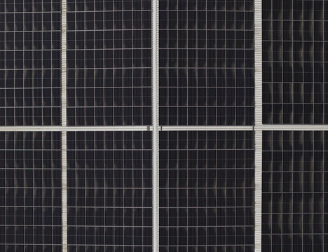 Portugal - 14 August 2026: Aerial view of solar panels installed on a factory rooftop, showcasing decentralized energy production.