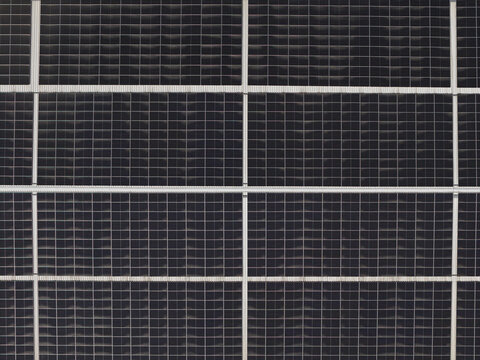 Portugal - 14 August 2026: Aerial view of solar panels installed on a factory rooftop, showcasing decentralized energy production with a grid of photovoltaic cells.