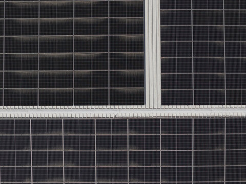 Portugal - 14 August 2026: Aerial view of solar panels installed on a factory rooftop, representing decentralized solar energy production in Portugal.