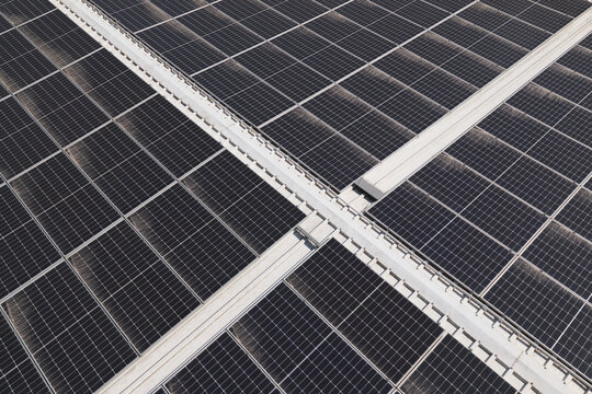 Portugal - 14 August 2026: Aerial view of solar panels installed on a factory rooftop, showcasing decentralized solar energy production in Portugal.