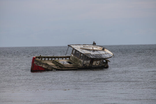 Fishing Boat Shipwreck Lying on Its Side in the Sea