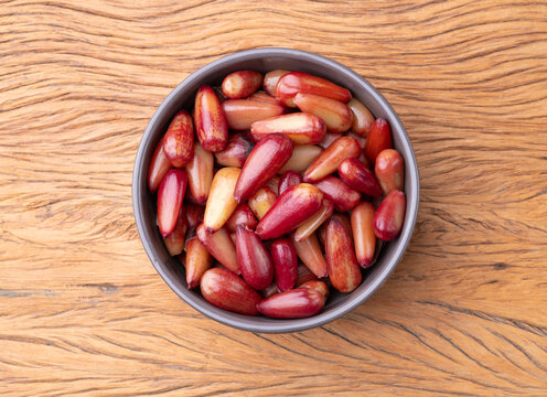 Cooked pinions or araucaria seeds on a bowl over wooden table