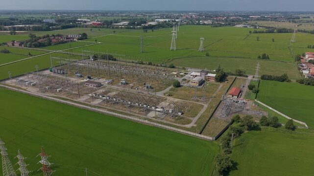 Aerial view of an electrical substation near Milan, showing high voltage equipment, transmission infrastructure