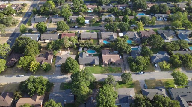 Spacious residential parcels feature private swimming pools near Little Bear Creek. Paved streets, detached garages, dense oak canopies highlight established suburban living, Hurst, Texas