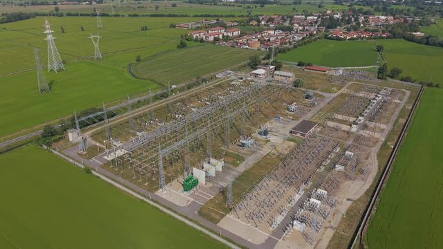 Aerial view of an electrical substation in Lacchiarella, Milan, Italy, showing high-voltage infrastructure and equipment supporting the regional power grid.