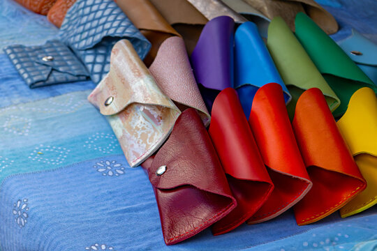 Multicoloured leather eyeglasses cases sold outside on market