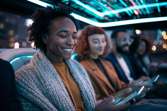 Diverse Commuters Traveling in Futuristic Autonomous Vehicle at Night