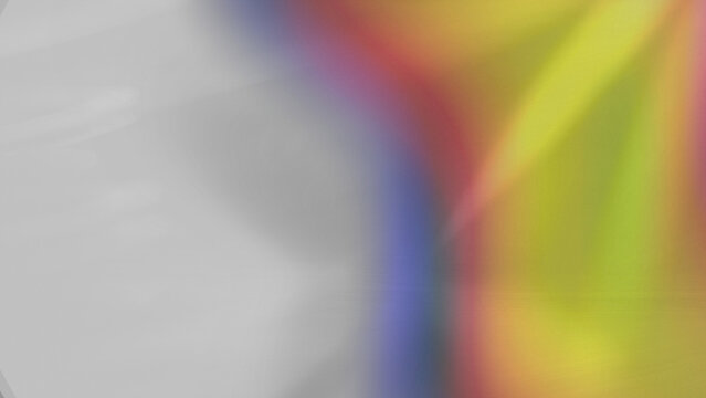 Rainbow light leak overlay texture with vivid color wave pattern glowing across bright textured paper for background