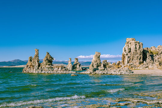 Weathered tufa towers stand partly submerged in the rippling waters of Mono Lake.