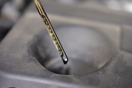 Engine oil on car dipstick during an oil level check