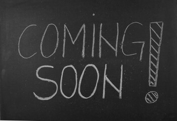Coming soon text written on a blackboard © Predrag