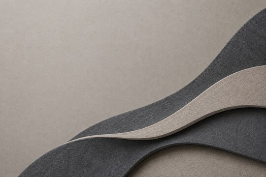 Acoustic felt wave texture in charcoal and greige with copy space