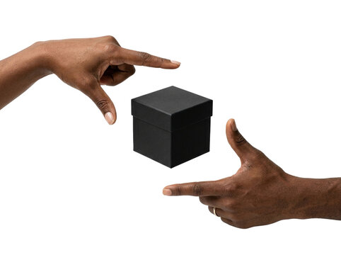 Black hands framing a small box, transparent background