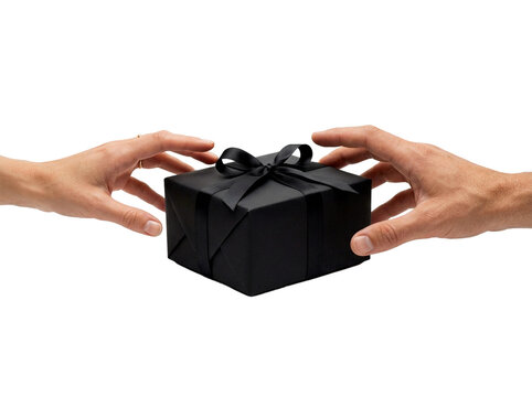 Hands exchanging a black gift box with ribbon, transparent background