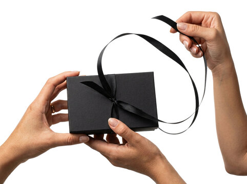 Female hands opening elegant black gift box, transparent background