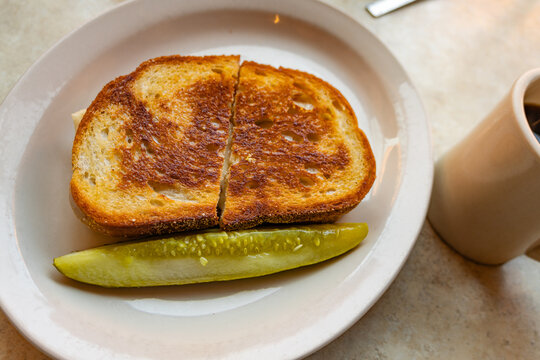 Close up of a grilled cheese and tomato sandwich on a table at a local diner.