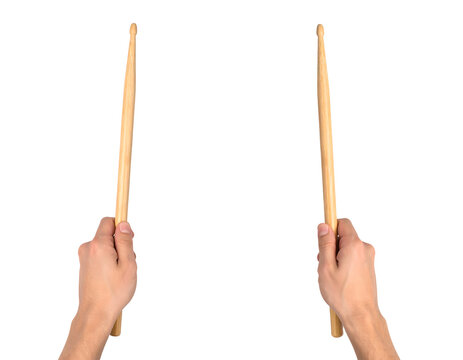 Drumsticks held by human hands representing a musician playing percussion instruments with wooden sticks&nbsp;
