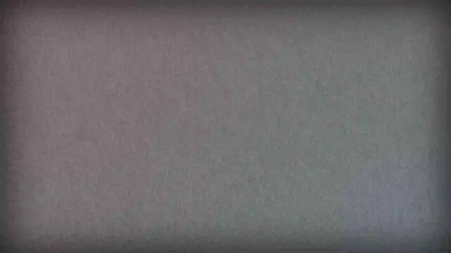 A gritty cinematic texture featuring heavy film grain and a distinct dark vignette frame mimicking the visual aesthetic of old historical motion picture reels for professional creative video