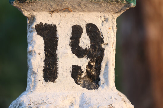 White number 19 on metal column