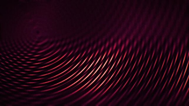 Crimson concentric wave ripples and liquid caustics bring a dark cinematic seamless loop for motion backgrounds, titles, VJ sets, and screensavers.