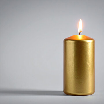 Golden candle with bright flame on gray background creating warm minimalist lighting and calm festive atmosphere for holiday celebration, meditation, ceremony, or home decoration new year concept