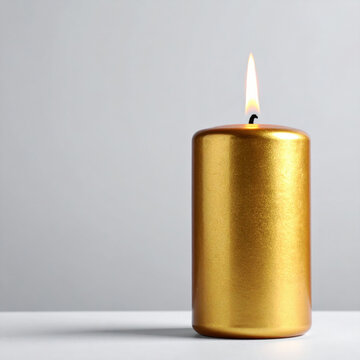 Golden candle with bright flame on white surface, creating warm minimalist atmosphere for celebration, meditation, relaxation, and festive home decor. new year concept