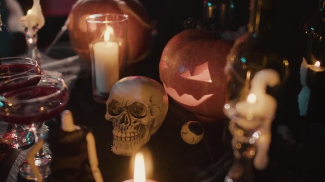 Halloween composition with glowing jack o lantern pumpkins and human skulls on dark background