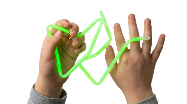 Childs hands playing with a green glow stick toy creating shapes and patterns PNG Isolated on transparent background