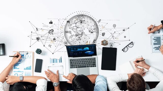 A dynamic business team engages in collaboration to analyze digital marketing data and strategize using modern technology in a professional office setting. Raster