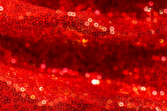  red sequins backdrop.sparkling waves textile.red sequin drapery with waves and glittering reflections for New Year celebrations,Christmas parties, gala posters,event invitations and premium designs.