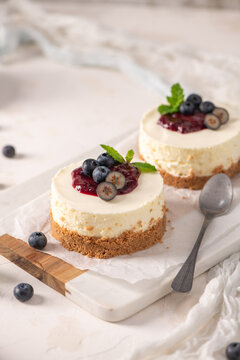 Mini cheesecakes with blueberry compote on a marble board