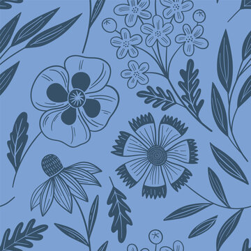 Seamless floral pattern with hand drawn wildflowers, daisies, coneflowers and leafy branches on a blue background.
