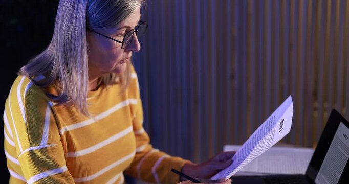 Writer working on her book in office at night