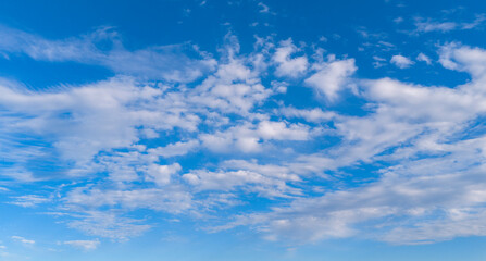 Fototapeta premium Clouds in sky background blue pattern. Soft white clouds on texture. Bright daylight clouds on wallpaper backdrop. Clouds cumulus skyscape.