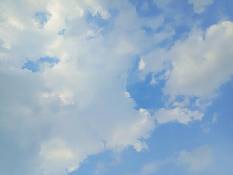 Dramatic soft white clouds drifting through a clear blue sky with atmosphere background meteorology sunlight