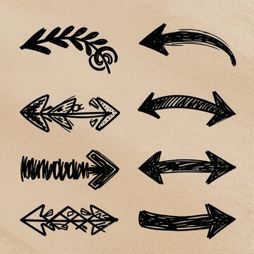 Hand drawn arrow doodles in black ink on a textured paper background
