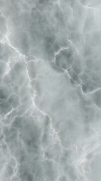 Soapstone texture close up of deep grey stone slab featuring intricate webbed white veins.