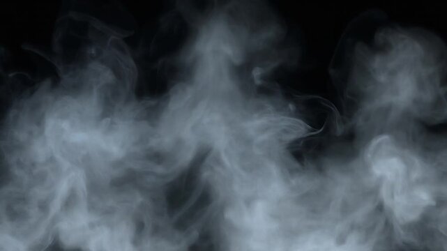 Thick white smoke swirls and billows against a dark black background, creating abstract ethereal patterns.