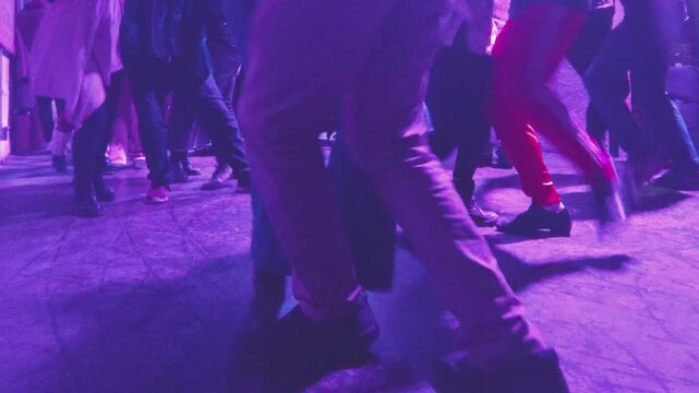 Montevideo, Uruguay: August 18 2026: Video shot handheld in medium shot shows a group of amateur adults couples dancing tango in a lively small nightclub in Montevideo, Uruguay.