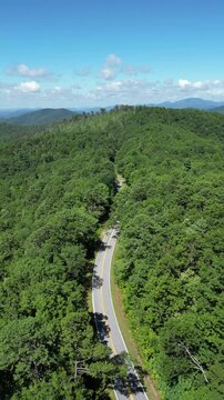 Aerial view overlooking a road winding through Oconee State Park with the foothills in the background in northwest South Carolina.