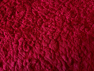 Close up of soft, fluffy plush fabric texture in vibrant magenta pink, perfect for backgrounds and comfort concepts © Andi Ibrahim